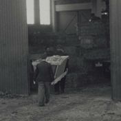 Kenteken: A 20018; De vrachtwagen in de fabriekshal, foto: still uit de film "Stro", Wim Mollema, 1947-1950, coll. GrA (2209-21259)