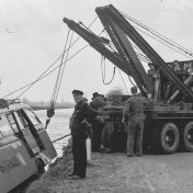 Kenteken: A 40091; Agent en mensen bij de takelwagen en bus van de DAM, 1955, foto: uitsnede 2248-7097.jpg; Fotograaf: Fotobedrijf Piet Boonstra