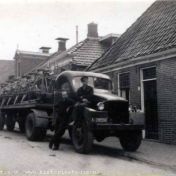 Kenteken: A 28096; GMC met vlasplukmachine, naast de auto J. Timmer, op de bumper J. de Ruiter. Molenstraat, Stedum, 1948, foto: via Stichting Historie Stedum; Fotograaf: Jan Timmer